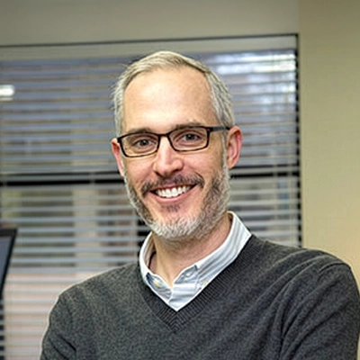 Orthodontist Gibson McCall Smiling In His Office