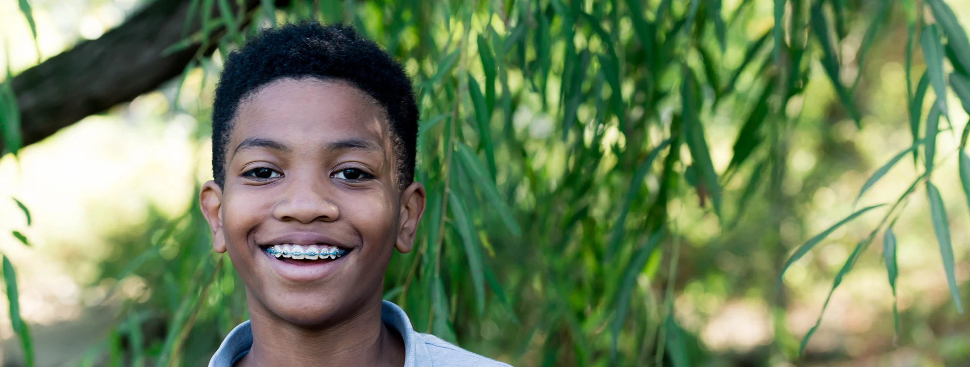 Happy Patient With Braces Smiling Outdoors